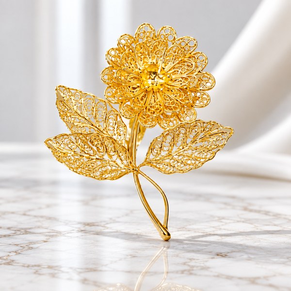 Hoa mạ vàng nghệ thuật với họa tiết filigree tinh xảo trên nền marble sáng. Hoa mạ vàng nghệ thuật với họa tiết filigree tinh xảo trên nền marble sáng.